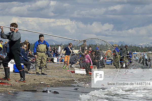 People dipnetting at the mouth of the Kenai River as it spills out into Cook Inlet in Southcentral Alaska during Summer