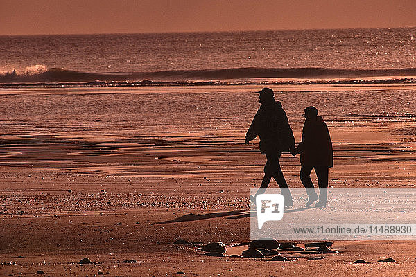 Elderly Couple Cook Inlet Silhouette Walking Alaska Southcentral Beach Anchor Point