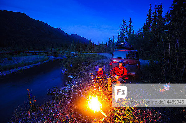 Father and son camping at Jack Creek off Nabesna Road in Wrangell Saint Elias National Park  Southcentral Alaska  Summer