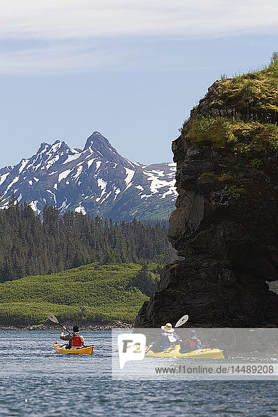 Visitors sea kayaking Eldred Passage Kachemak Bay w/Kenai Mtns Kenai Peninsula Alaska Summer