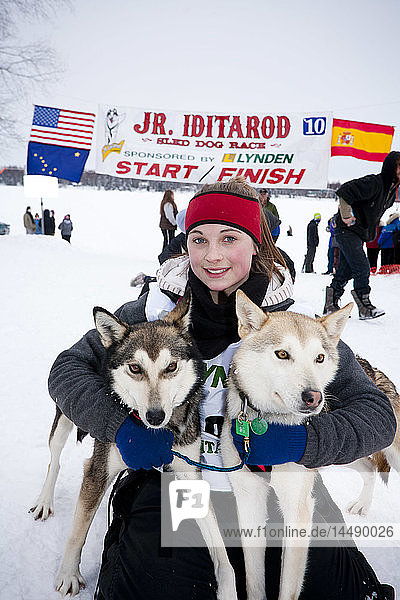 Merissa Osmar poses with her lead dogs Polly (L) and Pepsi (R) at the finish line shortly after winning the 2010 Junior Iditarod Sled Dog Race  Willow  Southcentral  AK