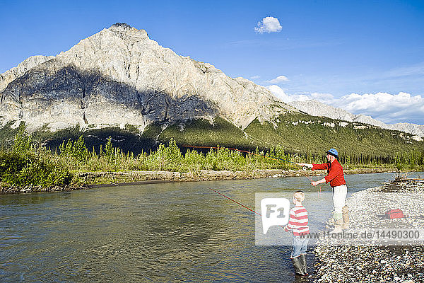 Father and son fishing on the Koyukuk River in the Brooks Range during Summer in Alaska