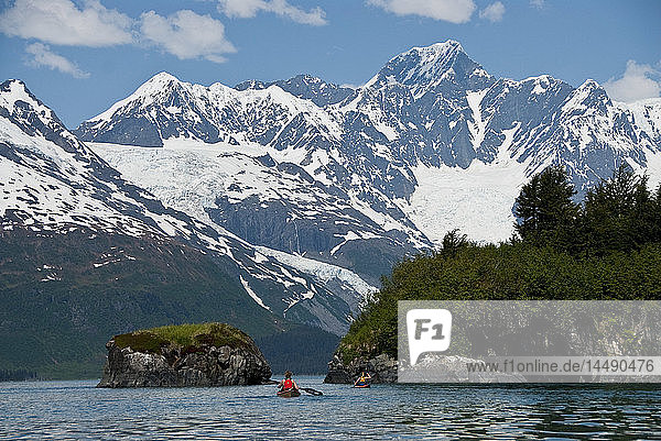 Kayakers paddling towards Black Sand Beach in Harriman Fjord  Chugach National Forest  Prince William Sound  Southcentral Alaska  Summer