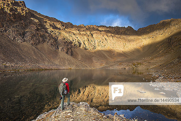 Male hiker enjoying the view of Hidden Lake Chugach State Park Southcentral Alaska