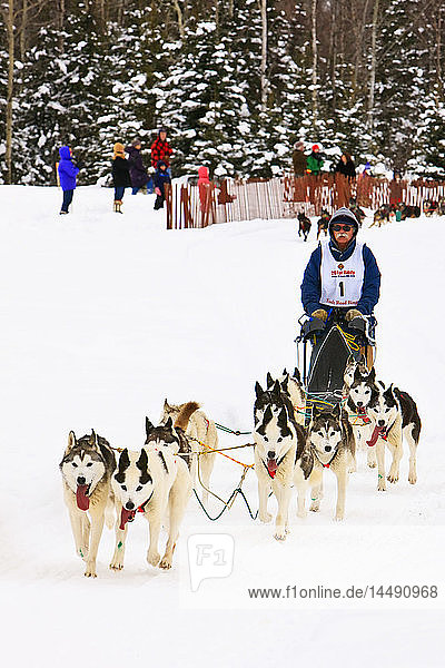 Musher J.P. Norris and sled dogs in the Fur Rendezvous World Sled Dog Championships on the Campbell Creek Trail in Anchorage  Southcentral Alaska