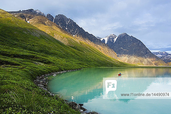 Woman canoeing in portable canoe on Turquoise Lake at Lake Clark National Park  Southcentral Alaska  Summer