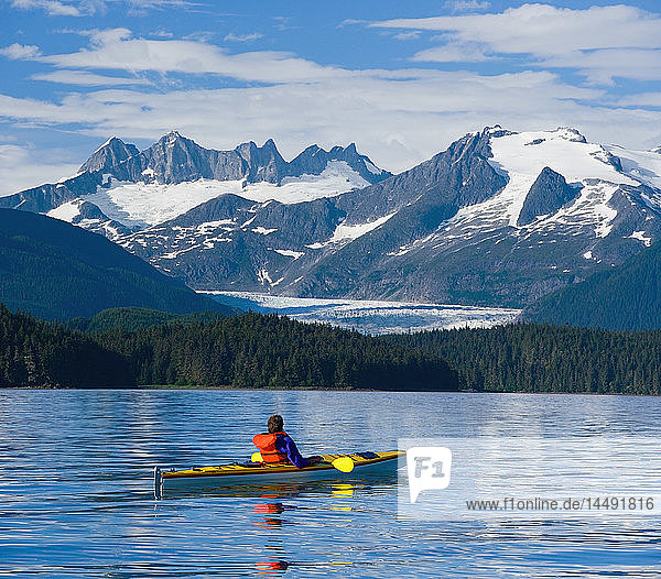 Sea kayaker in Inside Passage near Juneau viewing Mendenhall Glacier Coast Mtns Southeast AK Summer