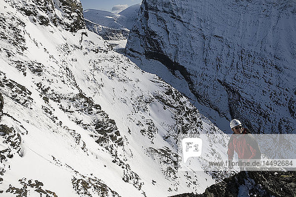 Man climbing up snowcapped Kebnekaise mountain