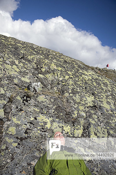 Woman resting on rock
