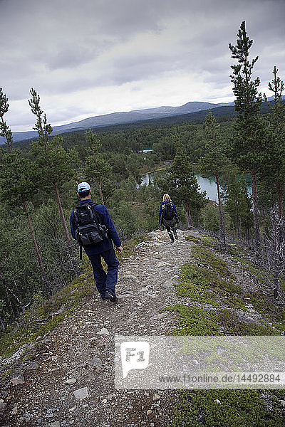 Two hikers hiking on mountains