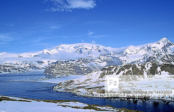 River flowing through snowcapped mountain range