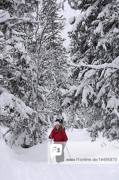 A skier with a child on her back  Dalarna  Sweden.
