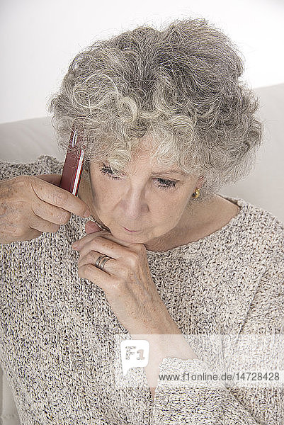 Ältere Frau am Telefon.