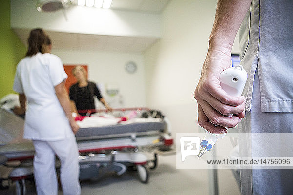 Reportage in the pediatric emergency unit in a hospital in Haute-Savoie France. A nurse gets ready to take a patient?s temperature.