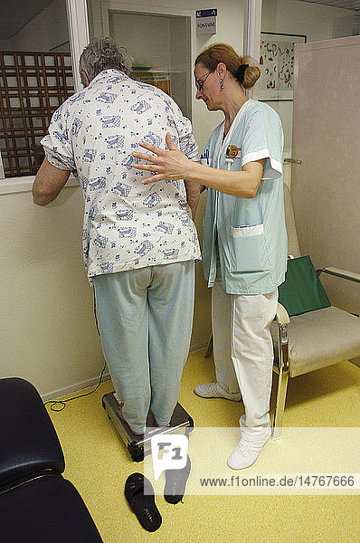 ELDERLY PERSON BEING WEIGHED