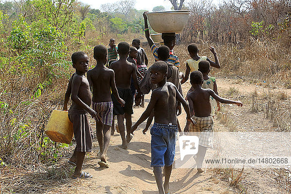 Africans children get water with a bucket.