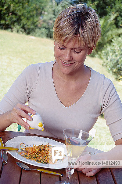 WOMAN EATING A MEAL