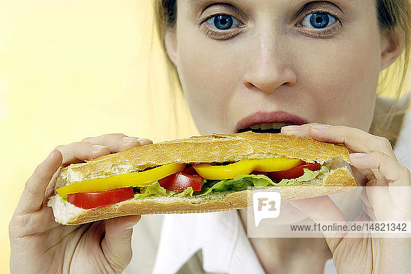 WOMAN EATING A SANDWICH