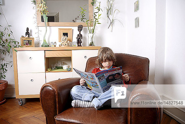 CHILD READING INDOORS