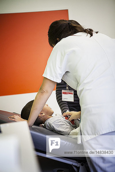 Reportage in the pediatric emergency unit in a hospital in Haute-Savoie France. A doctor examines a young patient.