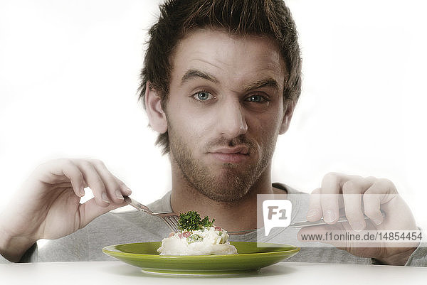 MAN EATING A MEAL