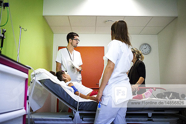 Reportage in the pediatric emergency unit in a hospital in Haute-Savoie  France. A nurse and an auxiliary nurse talk to a young patient and her mother.