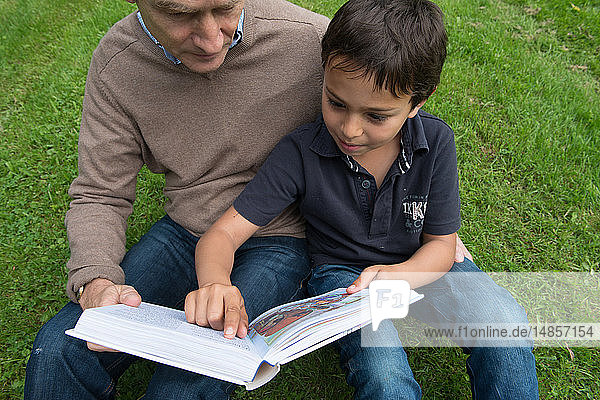 Father and son reading a children´s bible.