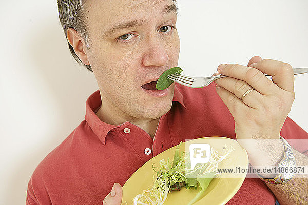MAN EATING SALAD