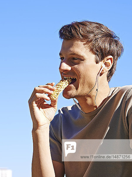 Man eating an energy bar.