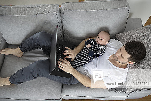 Man with baby on sofa