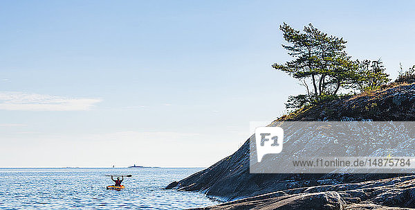 Man kayaking on sunny day