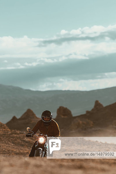 Motorcyclist riding in desert  Trona Pinnacles  California  US