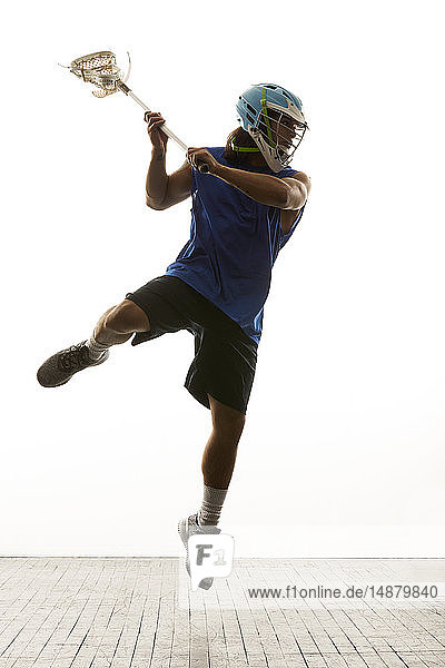 Man modelling lacrosse helmet and stick