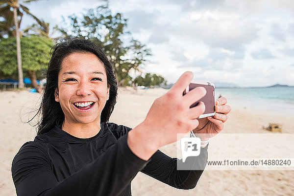 Woman taking photo on Kailua Beach  Oahu  Hawaii