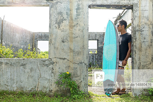 Surfer by doorway of abandoned building  Abulug  Cagayan  Philippines