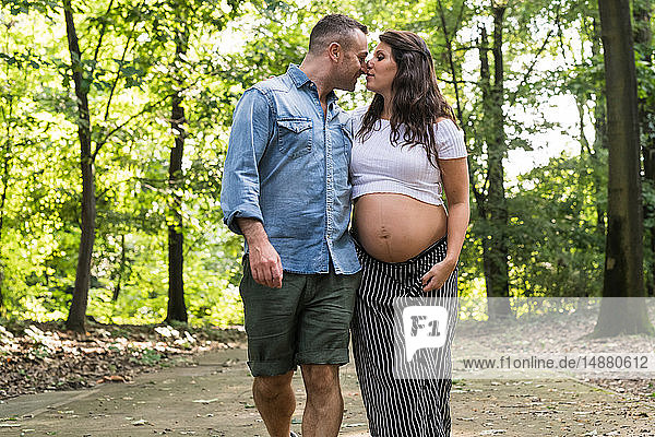 Affectionate pregnant couple in park