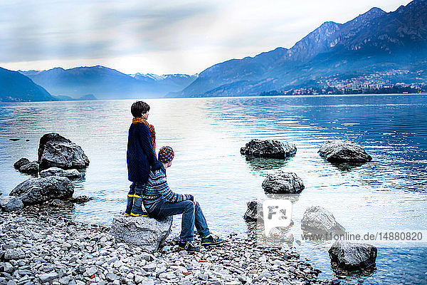 Father and son on lakeside  Onno  Lombardy  Italy
