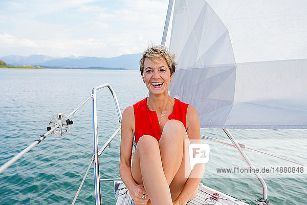 Mature woman sailing on Chiemsee lake  portrait  Bavaria  Germany
