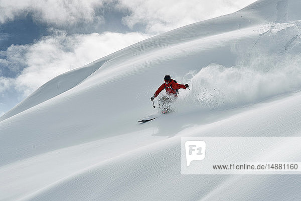 Male skier skiing down snow covered mountain  Alpe-d'Huez  Rhone-Alpes  France