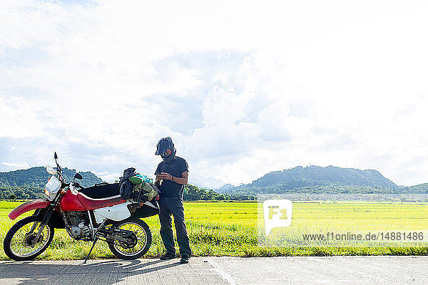 Motorcyclist stopping by roadside  Camalaniugan  Cagayan  Philippines