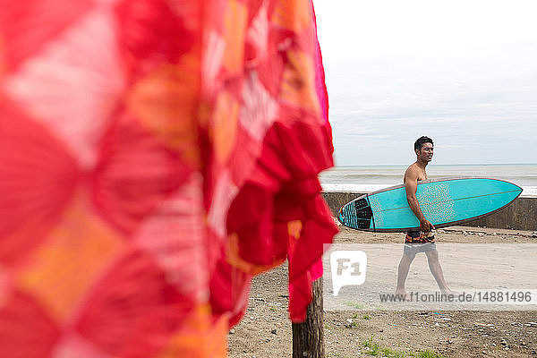 Surfer with surfboard on beach  Abulug  Cagayan  Philippines
