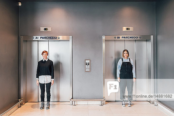 Friends standing in front of lift doors