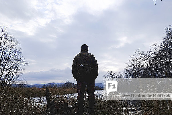 Man enjoying view by lake Ural Sverdlovsk Russia