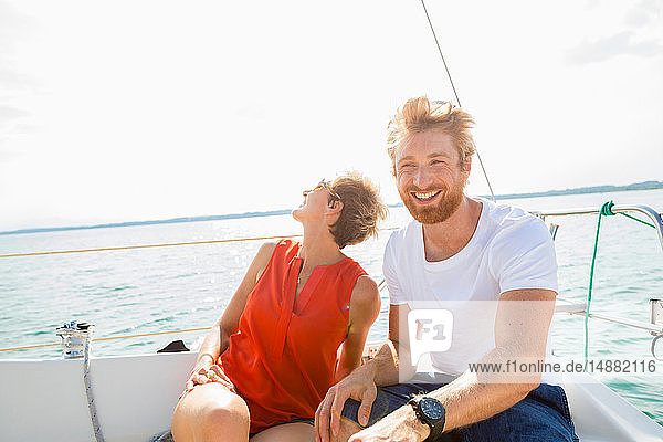 Young man and mature woman sailing on Chiemsee lake  Bavaria  Germany