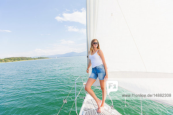 Young woman on sailboat on Chiemsee lake  portrait  Bavaria  Germany
