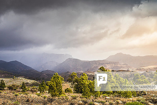 Landscape with distant mountains and storm clouds  Mogan  Canary Islands  Spain