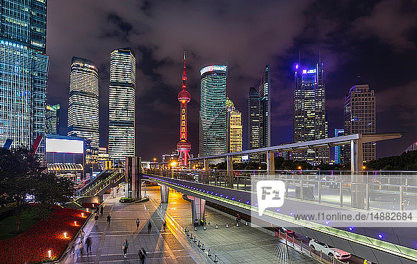 Pudong skyline with Oriental Pearl Tower and elevated walkway at night  Shanghai  China
