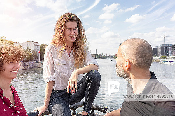 Mann und Freundinnen im Gespräch  Fluss im Hintergrund  Berlin  Deutschland