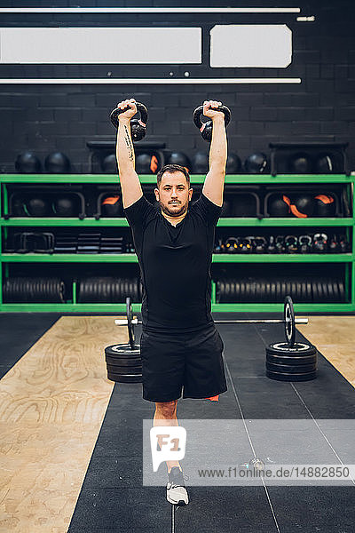 Man with disability using kettlebells in gym