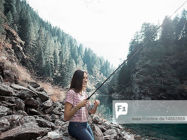Woman fishing in lake  Antronapiana  Piemonte  Italy